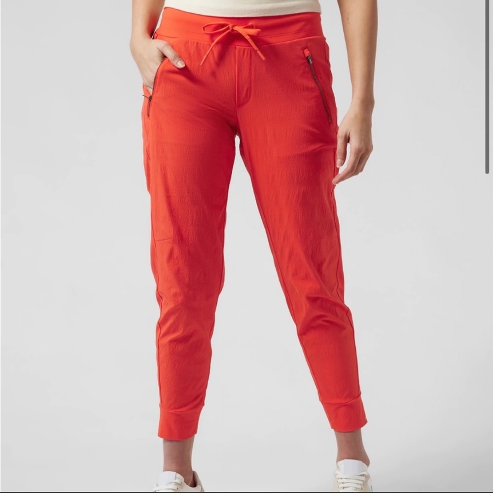 ATHLETA TREKKIE NORTH JOGGER PANTS IN FLAME ORANGE